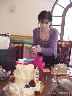 Enya about to cut the overly white-chocolate-fingered birthday cake 