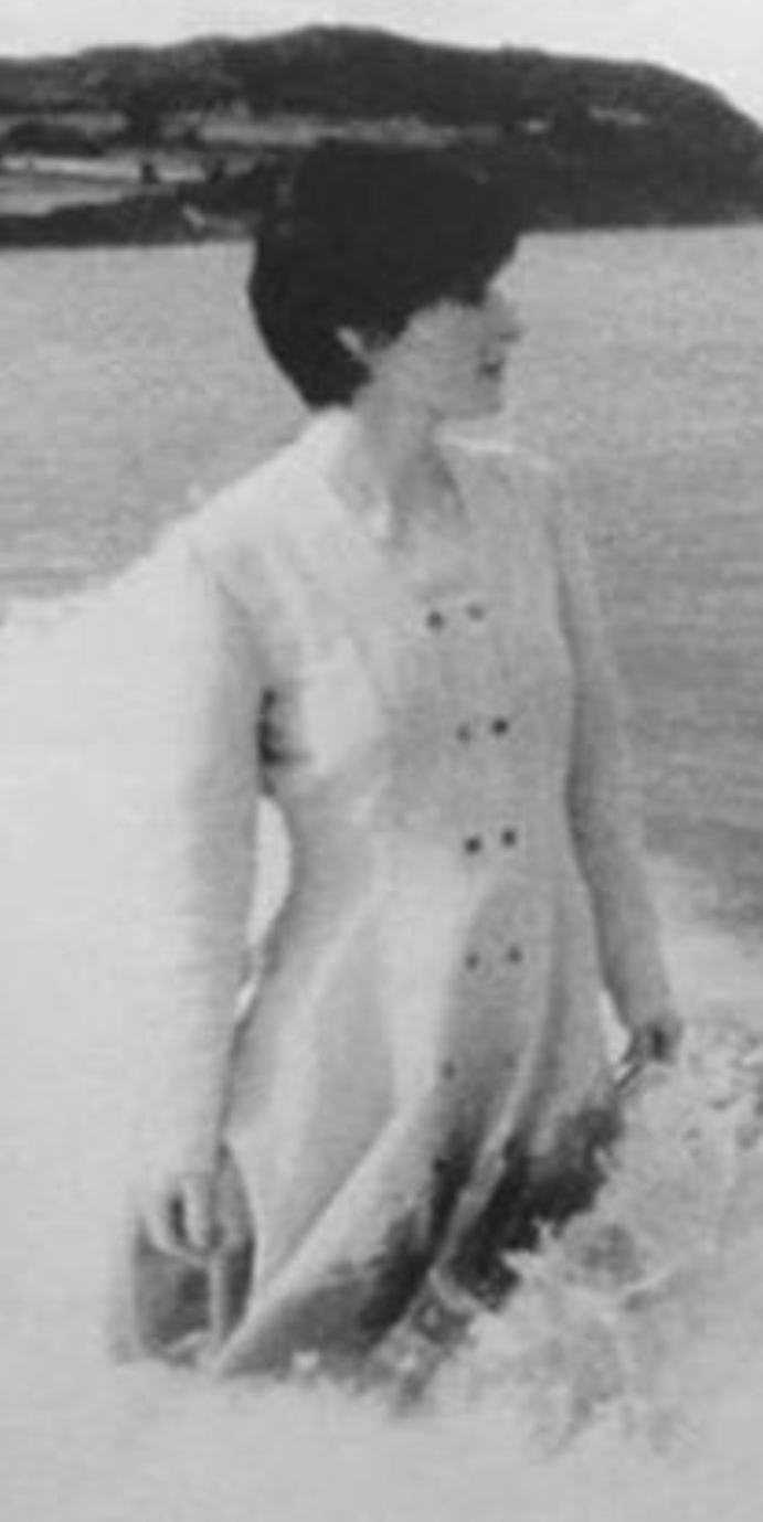 Enya standing in a sea wave c. 1988