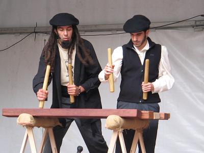 Two txalaparta players at a performance in a fiesta.jpg