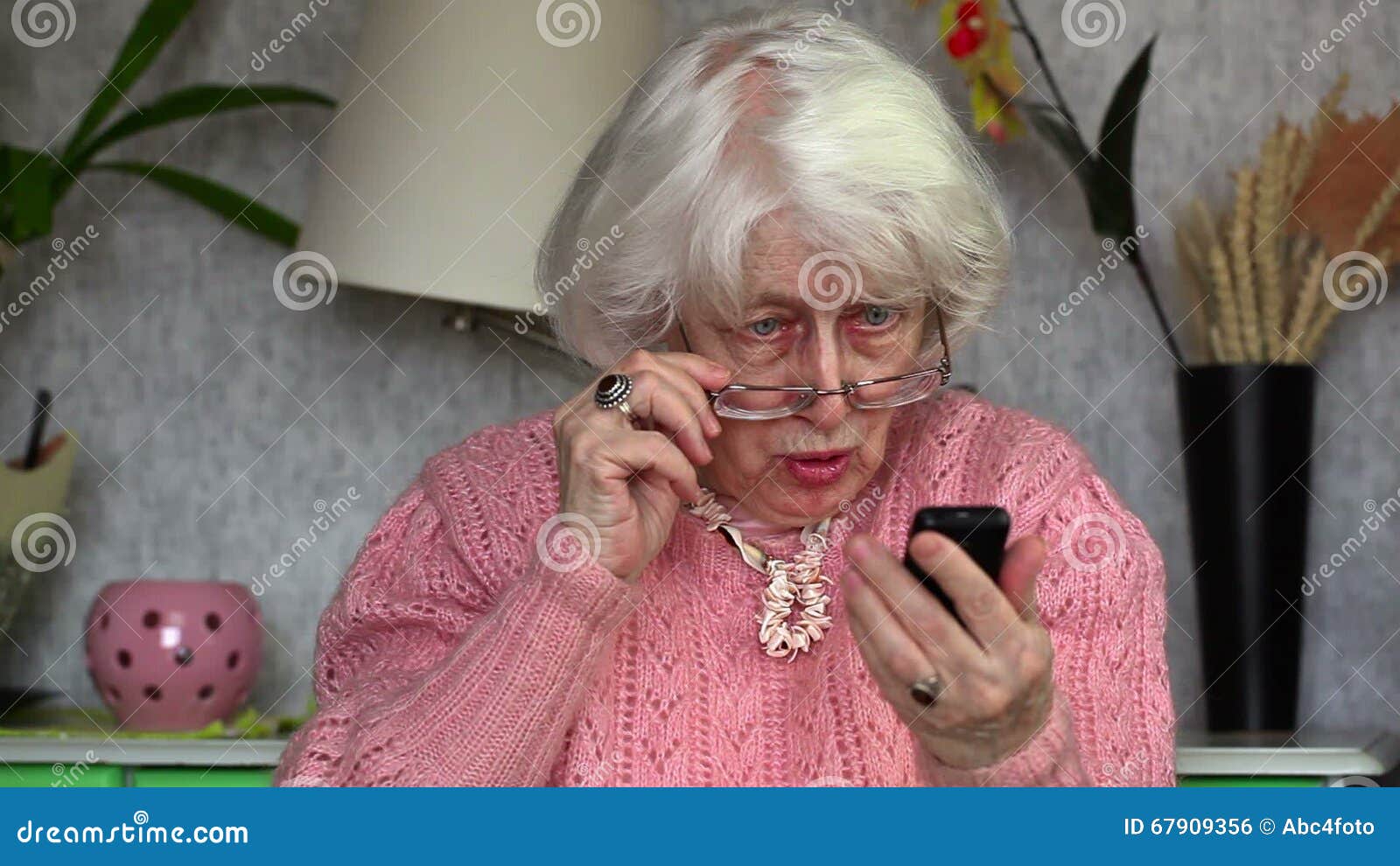 happy-old-woman-cell-phone-room-67909356.jpg