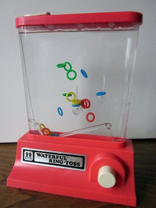 This may contain: a red toy machine sitting on top of a wooden table